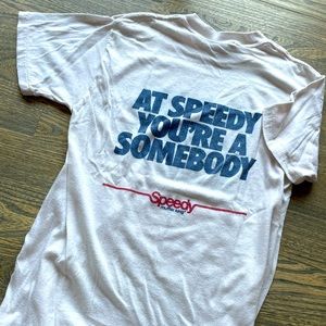 White Speedy Muffler King T-Shirt. Size is medium and cold wash with hang dry.